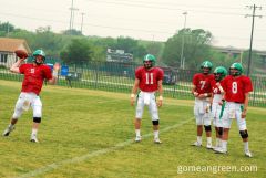 UNT QB Andy McNulty throws with teammates watching on