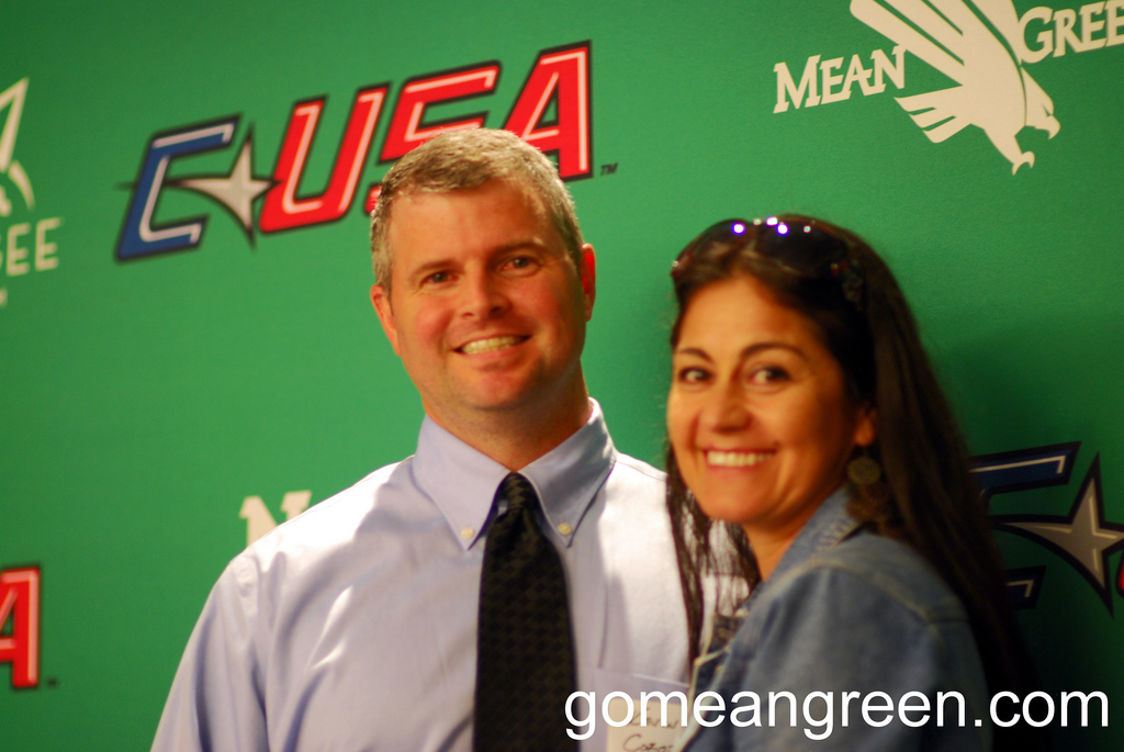 UNT Fans pose proudly in front of C-USA logo