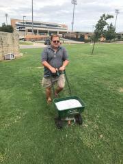tony fertilizing and de-anting the tailgate area prior to the 2017 season